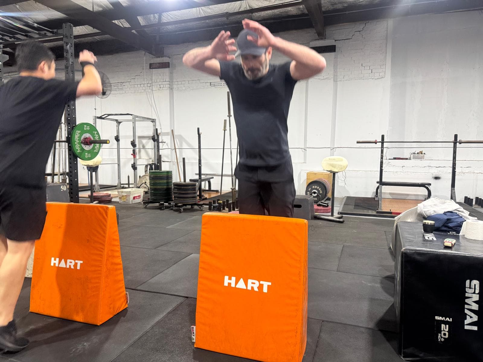 Members mid jump drill over hurdle wedges